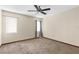 Bright bedroom featuring neutral walls, plush carpeting, a ceiling fan, and natural light from two windows at 2443 Glenridge Dr, Spring Hill, FL 34609