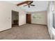 Bedroom featuring a vaulted ceiling, ceiling fan, and closet and bathroom doorway at 2443 Glenridge Dr, Spring Hill, FL 34609
