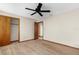 Bedroom features neutral paint, tan carpet, fan, and closet and bathroom doorway at 2443 Glenridge Dr, Spring Hill, FL 34609