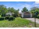 Charming single-Gathering home featuring a two-car garage and neutral stucco exterior, nestled amidst mature trees at 2443 Glenridge Dr, Spring Hill, FL 34609
