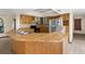 Functional kitchen featuring wooden cabinetry, matching countertops and appliances, with a breakfast bar at 2443 Glenridge Dr, Spring Hill, FL 34609