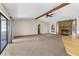 Spacious living room featuring a stone fireplace, wood beam accents, and sliding glass doors to the patio at 2443 Glenridge Dr, Spring Hill, FL 34609
