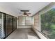 Screened-in patio featuring a ceiling fan, sliding glass doors, and access to the backyard at 2443 Glenridge Dr, Spring Hill, FL 34609