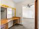Bright vanity area with a mirror and unique wooden countertop and carpeted bedroom at 2443 Glenridge Dr, Spring Hill, FL 34609