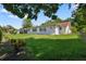 Expansive backyard with green lawn surrounding the home at 2866 Thistle N Ct, Palm Harbor, FL 34684
