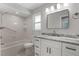 Bathroom with white vanity, updated fixtures, granite counters and shower-tub combo at 2866 Thistle N Ct, Palm Harbor, FL 34684