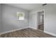 Empty bedroom showcasing luxury vinyl plank flooring, bright window, and neutral color scheme at 2866 Thistle N Ct, Palm Harbor, FL 34684