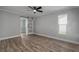 Bedroom features fan, sliding barn door, and wood-look floors, great for restful nights at 2866 Thistle N Ct, Palm Harbor, FL 34684