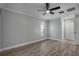 Bedroom with wood-look floors, natural light, and a ceiling fan for comfort and style at 2866 Thistle N Ct, Palm Harbor, FL 34684