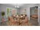 Inviting dining area with stylish decor, a large window with shutters, and a view into the living room at 2866 Thistle N Ct, Palm Harbor, FL 34684