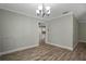 Open dining area featuring wood flooring, neutral walls, and doorway that leads to the kitchen at 2866 Thistle N Ct, Palm Harbor, FL 34684