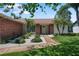 Close up of home's entrance with brick accents, decorative plants, and inviting front door at 2866 Thistle N Ct, Palm Harbor, FL 34684