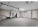 Spacious garage with painted floor, utility sink, and ample room for storage and vehicles at 2866 Thistle N Ct, Palm Harbor, FL 34684