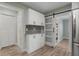 Updated kitchen with cabinets and sliding barn door to a walk-in pantry at 2866 Thistle N Ct, Palm Harbor, FL 34684
