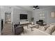 Staged living room with modern furniture, accent wall, and cozy atmosphere, perfect for relaxing at 2866 Thistle N Ct, Palm Harbor, FL 34684