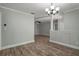Open-concept living room features wood-look floors and neutral paint scheme, great for entertaining at 2866 Thistle N Ct, Palm Harbor, FL 34684