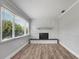 Bright living room featuring a stone fireplace, modern floors, and ample natural light through large windows at 2866 Thistle N Ct, Palm Harbor, FL 34684