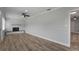 Bright living room with stone fireplace, ceiling fan, wood floors, and view to adjacent space at 2866 Thistle N Ct, Palm Harbor, FL 34684