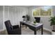 Home office featuring black desk, comfortable seating, bright window with natural light, and stylish decor at 2866 Thistle N Ct, Palm Harbor, FL 34684
