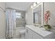 Updated bathroom with tiled shower, modern vanity, and stylish decor at 3907 Headsail Dr, New Port Richey, FL 34652