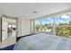 This bedroom boasts large windows showcasing beautiful outdoor views of lush landscaping and canals at 3907 Headsail Dr, New Port Richey, FL 34652