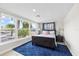 Bright bedroom features large windows with peaceful water views, a blue rug, and classic furnishings at 3907 Headsail Dr, New Port Richey, FL 34652