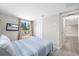 Inviting bedroom with tiled floors, ample lighting, and mounted TV for relaxation at 3907 Headsail Dr, New Port Richey, FL 34652