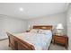 Bedroom with wood bed frame, white closet doors, and neutral walls and decor at 3907 Headsail Dr, New Port Richey, FL 34652