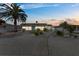 Exterior view of a home at dusk with palm trees and a gravel yard at 3907 Headsail Dr, New Port Richey, FL 34652