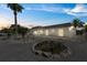 Single-story home in evening with rock landscaping and a two-car garage at 3907 Headsail Dr, New Port Richey, FL 34652