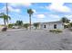 Single-story home with a gravel yard, palm trees, and tasteful landscaping at 3907 Headsail Dr, New Port Richey, FL 34652
