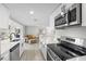 This modern kitchen offers stainless steel appliances, quartz counters, and a view into the living area at 3907 Headsail Dr, New Port Richey, FL 34652