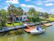 Stunning aerial view showcasing a waterfront home with a private dock and lush landscaping at 4292 Tahiti Dr, Hernando Beach, FL 34607