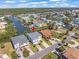 Expansive aerial view of waterfront property in a canal community, showcasing a charming home and lush landscaping at 4292 Tahiti Dr, Hernando Beach, FL 34607