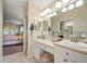 Primary bath boasts double sinks, bright vanity lighting, and views of the water at 4292 Tahiti Dr, Hernando Beach, FL 34607