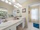 Bright bathroom with double sink vanity, decorative lighting, and tiled floors at 4292 Tahiti Dr, Hernando Beach, FL 34607