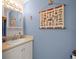 Powder room with nautical wall decorations, decorative mirror, and simple sink and vanity at 4292 Tahiti Dr, Hernando Beach, FL 34607