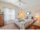 Cozy bedroom features a ceiling fan, natural light, and coastal themed decor at 4292 Tahiti Dr, Hernando Beach, FL 34607