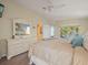 Bright main bedroom with a large bed, dresser, and access to a private balcony at 4292 Tahiti Dr, Hernando Beach, FL 34607