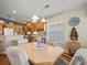 Charming dining area featuring hardwood floors, elegant lighting, and a view into the well-appointed kitchen at 4292 Tahiti Dr, Hernando Beach, FL 34607