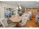 Open-concept dining area with hardwood floors, modern lighting, and easy access to the kitchen and patio at 4292 Tahiti Dr, Hernando Beach, FL 34607