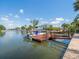 Home with a private boat dock on a sunny day, offering easy access to the water at 4292 Tahiti Dr, Hernando Beach, FL 34607