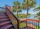 Staircase view of waterfront with lush greenery and palm trees at 4292 Tahiti Dr, Hernando Beach, FL 34607