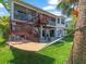 Rear exterior view of house, with deck, patio and waterfront access at 4292 Tahiti Dr, Hernando Beach, FL 34607