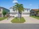 Well-maintained two-story home with a driveway, boat trailer, and garage spaces at 4292 Tahiti Dr, Hernando Beach, FL 34607