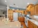 Spacious kitchen featuring ample cabinet space, modern appliances, a breakfast bar, and custom backsplash at 4292 Tahiti Dr, Hernando Beach, FL 34607