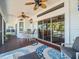 Spacious screened lanai offers outdoor dining and relaxation areas, ceiling fans, and access to tropical scenery at 4292 Tahiti Dr, Hernando Beach, FL 34607