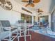 Inviting screened lanai featuring casual seating, ceiling fans, and serene views for outdoor enjoyment at 4292 Tahiti Dr, Hernando Beach, FL 34607