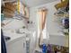 Laundry room with modern appliances, sink, and storage racks at 4292 Tahiti Dr, Hernando Beach, FL 34607