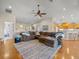 Open-concept living room with hardwood floors, fan, and seamless flow into the kitchen and other living spaces at 4292 Tahiti Dr, Hernando Beach, FL 34607